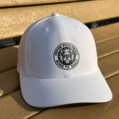 White cap with a black logo on a wooden surface